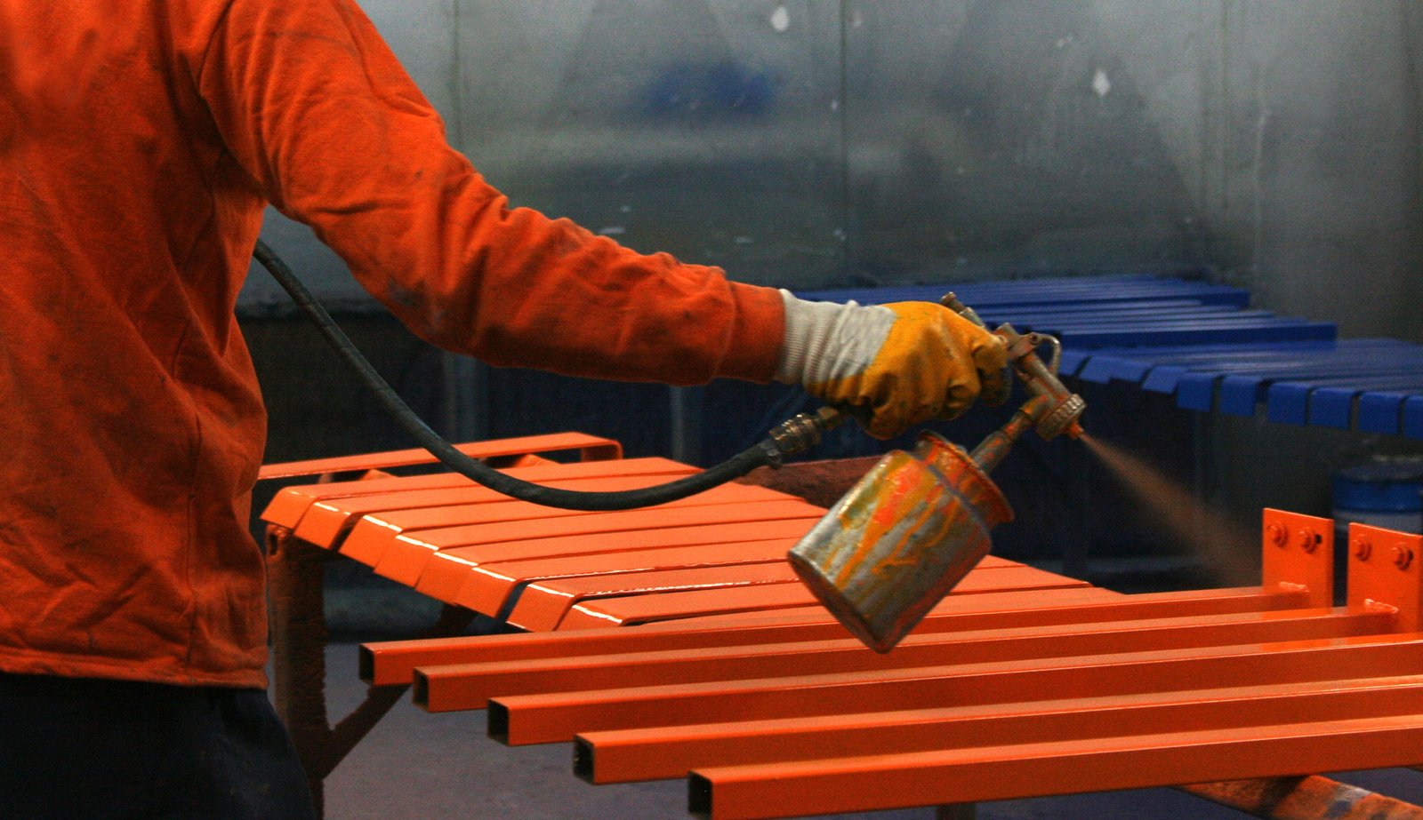 Metal painting worker in factory